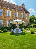 ASHBROOK HOUSE, NORTHAMPTONSHIRE: SUMMER, PARASOL, UMBRELLA BY TITANIA, LAWN, TABLE, CHAIRS, ENTERTAINING