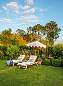 ASHBROOK HOUSE, NORTHAMPTONSHIRE: SUMMER, LAWN, SUNLOUNGERS, PARASOL, UMBRELLA BY TITANIA, BORDERS