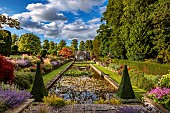 THE SUMMERHOUSE, OXFORDSHIRE: JULY, SUMMER, VIEW ALONG CANAL, POND, POOL, WATER, GARDEN TO HOUSE, BORDERS, YEW PYRAMIDS, MAPLES, TREES, WATERLILIES, COTSWOLDS