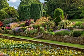 THE SUMMERHOUSE, OXFORDSHIRE: JULY, SUMMER, CANAL, POND, POOL, WATER, GARDEN, BORDERS, TREES, WATERLILIES, STONE, STEPS, WALLS, YEW, ROSE BONICA, STIPA GIGANTEA, PHORMIUMS