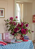 ASHBROOK HOUSE, NORTHAMPTONSHIRE: MOLLY MAHON PRODUCTS ON TABLE, DAHLIAS IN VASE