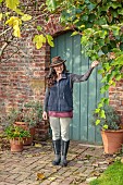 THE LAUNDRY GARDEN, DENBIGH, WALES: JENNY WILLIAMS BY FIG BESIDE THE WALLED GARDEN ENTRANCE, WALLS, BLUE GATE, NOVEMBER, FALL