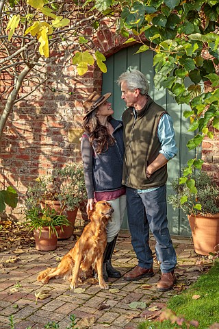 THE_LAUNDRY_GARDEN_DENBIGH_WALES_JENNY_AND_TOM_WILLIAMS_WITH_THEIR_DOG_AT_THE_WALLED_GARDEN_ENTRANCE
