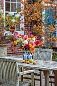 THE LAUNDRY GARDEN, DENBIGH, WALES: FALL, NOVEMBER, TABLE, CHAIRS, PATIO, CONTAINER, ARRANGEMENT OF DAHLIAS BY JENNY WILLIAMS
