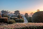 BRODSWORTH HALL, YORKSHIRE: DAWN, SUNRISE, WINTER, JANUARY, FROST, SNOW, CLIPPED TOPIARY HEDGES, HEDGING, EVERGREENS, VICTORIAN, PATHS