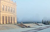 BRODSWORTH HALL, YORKSHIRE: DAWN, SUNRISE, WINTER, JANUARY, FROST, CLIPPED TOPIARY SHRUBS, HEDGES, HEDGING, EVERGREENS, VICTORIAN, PATHS, BORDERS, FORMAL, GARDEN, MIST, FOG
