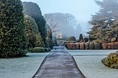 BRODSWORTH HALL, YORKSHIRE: WINTER, JANUARY, FROST, CLIPPED TOPIARY SHRUBS, HEDGES, HEDGING, EVERGREENS, VICTORIAN, PATHS, FORMAL, GARDEN, MIST, FOG, STONE SUMMERHOUSE