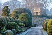 BRODSWORTH HALL, YORKSHIRE: WINTER, JANUARY, FROST, CLIPPED TOPIARY SHRUBS, HEDGES, HEDGING, EVERGREENS, VICTORIAN, PATHS, FORMAL, GARDEN, MIST, FOG, STONE SUMMERHOUSE