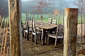 LONGYARD COTTAGE, ESSEX: WINTER, FEBRUARY, MIST, FOG, FOGGY, WOODEN TABLE AND CHAIRS ON PATIO