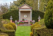 THE LASKETT, HEREFORDSHIRE: APRIL, THE V AND A TEMPLE, PLAQUE BY SIMON VERITY IN TEMPLE, CONTAINERS OF TULIPS, TULIPA CANDY PRINCE, TULIPA PURPLE PRINCE, BULBS, YEW HEDGING, HEDGES