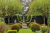 THE LASKETT, HERFEFORDSHIRE: DESIGNER ROY STRONG, APRIL, VIEW TO THE WILLIAM SHAKESPEARE MEMORIAL, CLIPPED TOPIARY, HEDGES, HEDGING, TREES