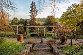 IFORD MANOR, WILTSHIRE: APRIL: SUNSET, TERRACE, CLASSICAL, GARDEN, STEPS, URNS, CONTAINERS, CHERRY, TULIPS, ITALIANATE, DESIGNER HAROLD PETO