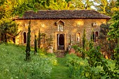 IFORD MANOR, WILTSHIRE: MAY, SPRING, GRASS PATH LEADING TO THE CLOISTERS, SUNSET, BUILDING