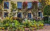 SILVER STREET FARM, DEVON: HOUSE FRONT WITH CLIMBERS, ROSA CHINENSIS MUTABILIS, ROSA BANKSIAE LUTEA, WISTERIA, CLIMBING, MAY, FRONT GARDEN, COUNTRY