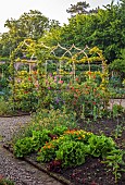 MORTON HALL GARDENS, WORCESTERSHIRE: ARCH IN KITCHEN GARDEN, POTAGER WITH SWEET PEAS