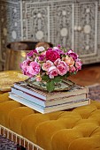 PRIVATE GARDEN, DEDHAM VALE, SUFFOLK: SITTING ROOM, ROSES FROM THE GARDEN ARRANGED ON AN ANTIQUE UPHOLSTERED FOOTSTOOL, CONSOLE