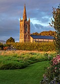 PATTHANA GARDEN, IRELAND: VIEW TO CHURCH, WILDFLOWER MEADOW, GRASS PATH, SEAT