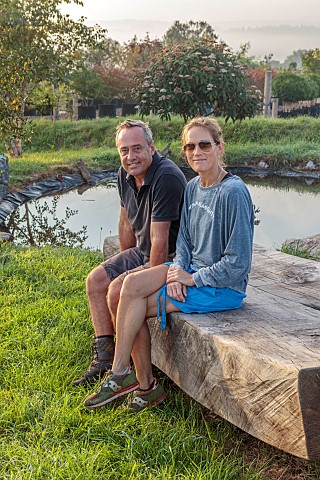NEW_WOOD_TREES_DEVON_TIFFANY_AND_PHILIP_NIEUWOUDT_SITTING_ON_A_HUGE_WOODEN_BENCH_SCULPTURE_BY_POND