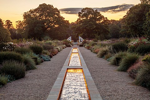 GRANTLEY_HALL_YORKSHIRE_LIGHTING_DAWN_GRAVEL_GARDEN_PATINATED_STEEL_AND_COLOURED_STAINLESS_STEEL_GLA