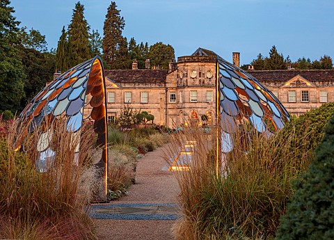 GRANTLEY_HALL_YORKSHIRE_LIGHTING_DAWN_GRAVEL_GARDEN_PATINATED_STEEL_AND_COLOURED_STAINLESS_STEEL_GLA