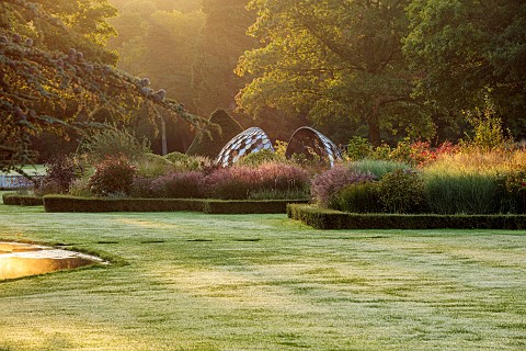 GRANTLEY_HALL_YORKSHIRE_LIGHTING_DAWN_BOX_EDGED_BEDS_WATER_POOL_PATINATED_STEEL_AND_COLOURED_STAINLE