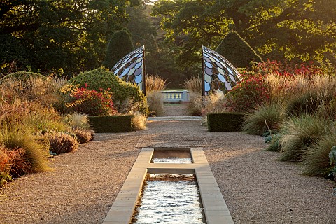 GRANTLEY_HALL_YORKSHIRE_LIGHTING_DAWN_BOX_EDGED_BEDS_WATER_POOL_PATINATED_STEEL_AND_COLOURED_STAINLE