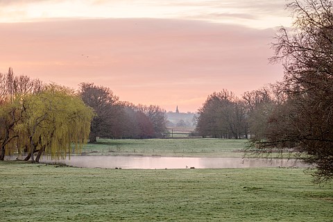 COTTESBROOKE_HALL_AND_GARDENS_NORTHAMPTONSHIRE_VIEW_FROM_SOUTH_TERRACE_OVER_LAKE_TO_BRIXWORTH_CHURCH