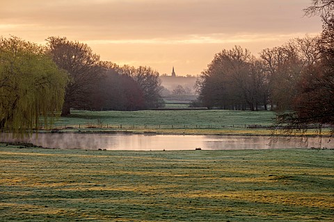 COTTESBROOKE_HALL_AND_GARDENS_NORTHAMPTONSHIRE_VIEW_FROM_SOUTH_TERRACE_OVER_LAKE_TO_BRIXWORTH_CHURCH