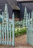 COLUMBINE HALL, SUFFOLK: WALLED GARDEN, MARCH, ORNAMENTAL GATES BY GEORGE CARTER, WHITE TULIPS