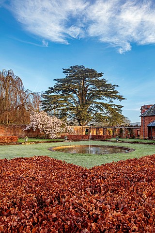 COTTESBROOKE_HALL_AND_GARDENS_NORTHAMPTONSHIRE_MARCH_SPRING_THE_POOL_GARDEN_MAGNOLIA_LAWN_FOUNTAIN_P