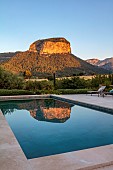PRIVATE GARDEN ALARO, MALLORCA, DESIGNED BY MASHAMBA DESIGN; THE PUIG DALARO MOUNTAIN REFLECTED IN THE SWIMMING POOL, DAWN, SUNRISE, REFLECTIONS