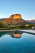 PRIVATE GARDEN ALARO, MALLORCA, DESIGNED BY MASHAMBA DESIGN; THE PUIG DALARO MOUNTAIN REFLECTED IN THE SWIMMING POOL, DAWN, SUNRISE, REFLECTIONS