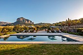 PRIVATE GARDEN ALARO, MALLORCA, DESIGNED BY MASHAMBA DESIGN: GRASS, SWIMMING POOL, REFLECTION OF PUIG DE SALCADENA MOUNTAIN, REFLECTED, APRIL