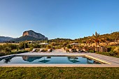 PRIVATE GARDEN ALARO, MALLORCA, DESIGNED BY MASHAMBA DESIGN: GRASS, SWIMMING POOL, REFLECTION OF PUIG DE SALCADENA MOUNTAIN, REFLECTED, APRIL