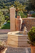 PRIVATE GARDEN ALARO, MALLORCA, DESIGNED BY MASHAMBA DESIGN: COURTYARD, FOUNTAIN, WALL, TERRACOTTA CONTAINERS, DECORATIVE COBBLED FLOOR