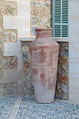 PRIVATE GARDEN ALARO, MALLORCA, DESIGNED BY MASHAMBA DESIGN: COURTYARD, WALL, TERRACOTTA CONTAINERS, DECORATIVE COBBLED FLOOR