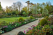 MORTON HALL GARDENS, WORCESTERSHIRE: APRIL, SPRING, BORDERS, TULIPS, SOUTH GARDEN, MORNING LIGHT, SUNRISE