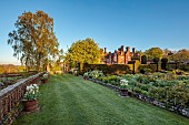 DODDINGTON PLACE, KENT: APRIL, SPRING, THE SUNKEN GARDEN, SUNRISE, TULIPS, HEDGES, HEDGING, TERRACOTTA CONTAINERS PLANTED WITH TULIPA ANGELS WISH, FLAMING AGRASS, FIRST PROUD