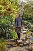 DODDINGTON PLACE, KENT: OWNER AMICIA OLDFIELD IN THE ROCK GARDEN, APRIL, SPRING