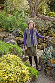 DODDINGTON PLACE, KENT: OWNER AMICIA OLDFIELD IN THE ROCK GARDEN, APRIL, SPRING