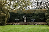 DODDINGTON PLACE, KENT: APRIL, SPRING, HUGE CLIPPED YEW HEDGE, HEDGING, CHAIRS, BENCHES, SCULPTURE