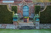 DODDINGTON PLACE, KENT: TERRACE, BLUE DOOR, COPPER CONTAINERS PLANTED WITH WHITE TULIPS, YEW HEDGES, HEDGING, SPRING, APRIL
