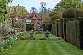 DODDINGTON PLACE, KENT: LAWN, BORDER, YEW HEDGES, HEDGING, COPPER CONTAINERS PLANTED WITH WHITE TULIPS, APRIL