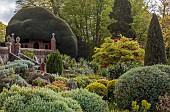 DODDINGTON PLACE, KENT: APRIL, SPRING, THE ROCK GARDEN, BALLOTA, WALLS, ACERS, MAPLES