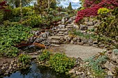 DODDINGTON PLACE, KENT: LARGE POOL, POND, QUARRY, ROCK GARDEN, MAPLES, ACERS, WATER, REFLECTIONS, REFLECTED, STREAM, SEAT, BENCH