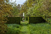 DODDINGTON PLACE, KENT: APRIL, SPRING, WOODLAND, PATH, HEDGES, HEDDGING, DAVID HARBER OBELISK