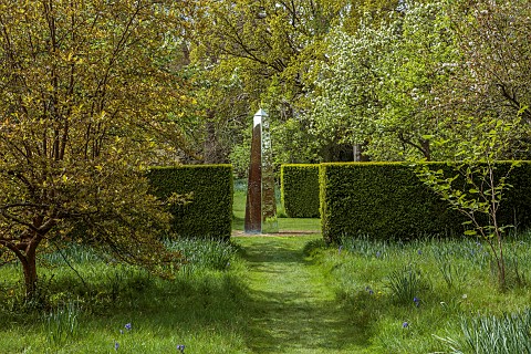 DODDINGTON_PLACE_KENT_APRIL_SPRING_WOODLAND_PATH_HEDGES_HEDDGING_DAVID_HARBER_OBELISK