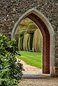 DODDINGTON PLACE, KENT: PATH, VIEW THROUGH FOLLY, BENCHES, SEATS, YEW HEDGES, HEDGING