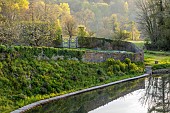 CAISSON GARDEN, SOMERSET: VIEW DOWN TO THE POUND, POND WITH ENGLISH OAK BOARDWALK, DECK, EUPHORBIA PALUSTRIS, LAMIUM ORVALA