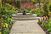 MORTON HALL GARDENS, WORCESTERSHIRE: APRIL, SPRING, BORDERS, TULIPS, SOUTH GARDEN, FOUNTAIN, WATER, PATH